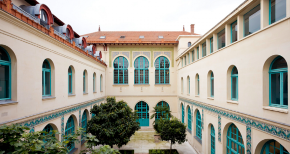 Photo of a white villa with green windows